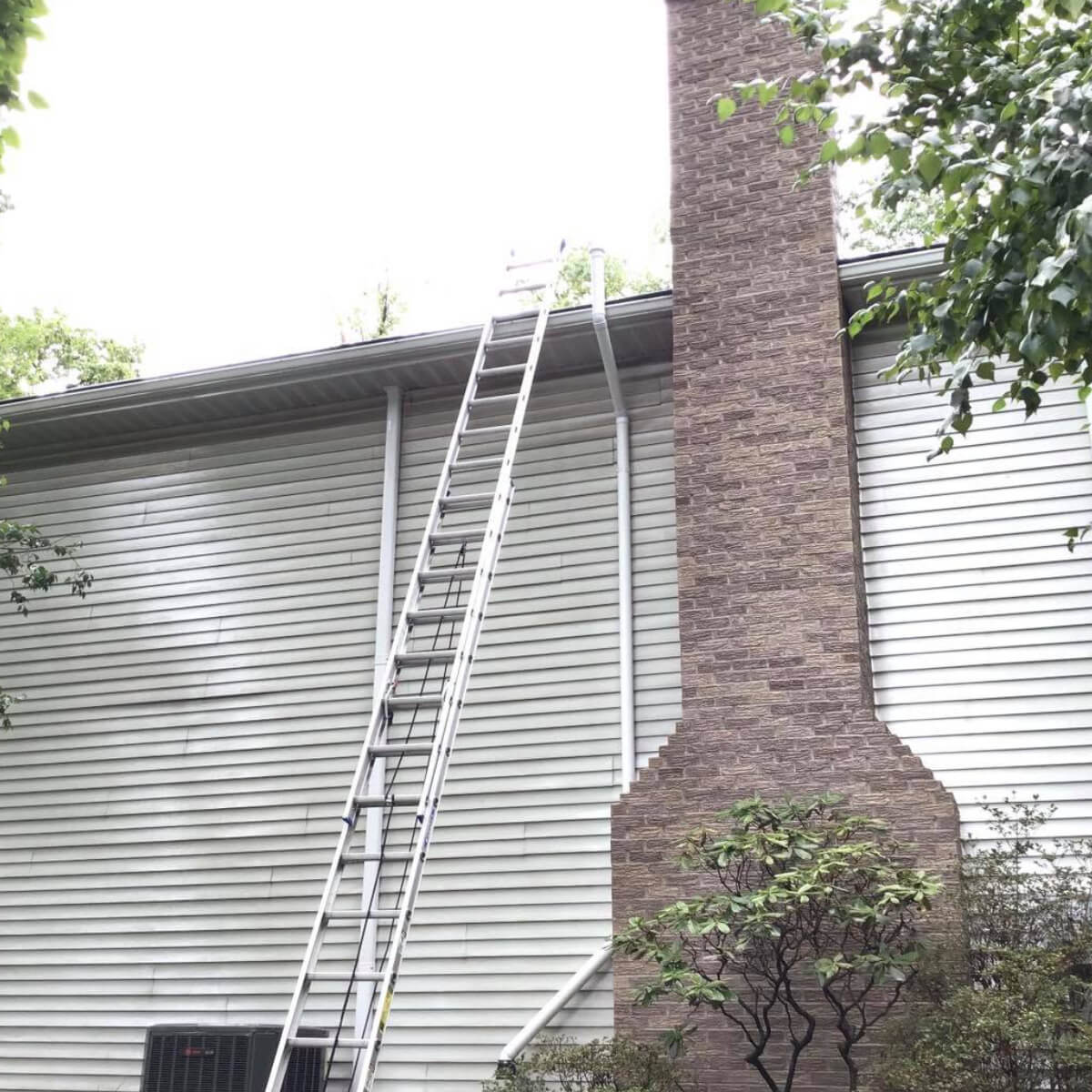 professional gutter cleaning contractors on residential roof in lansdale pa